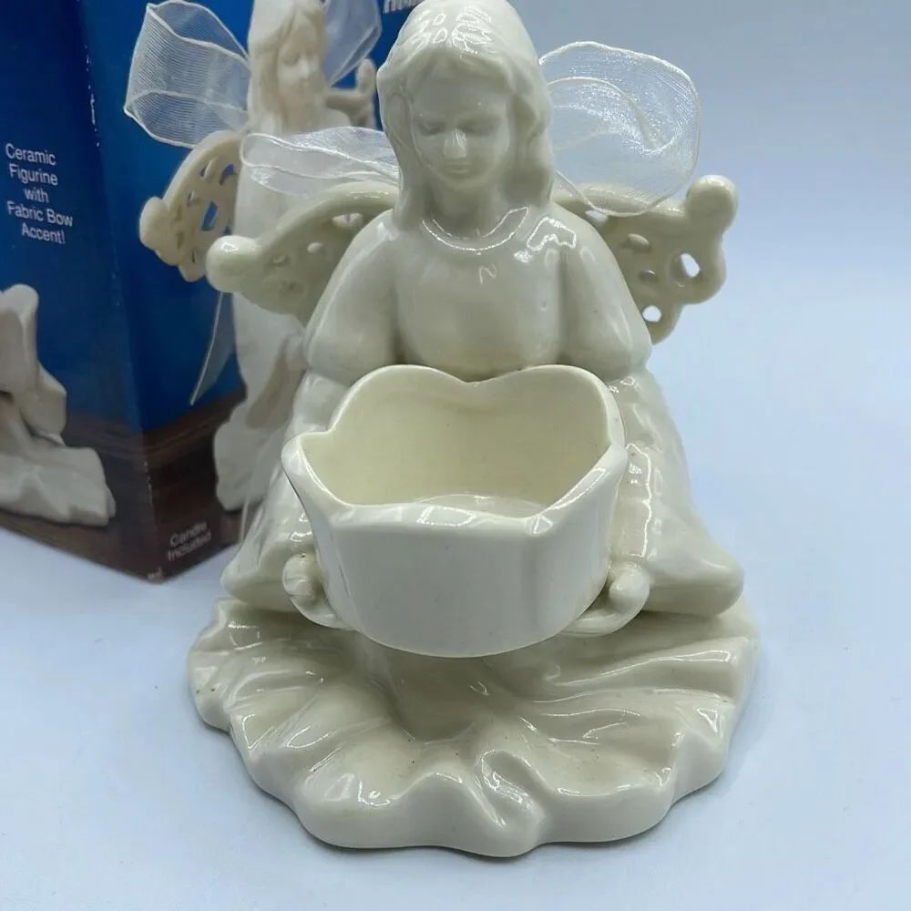 Ceramic angel tea light holder .